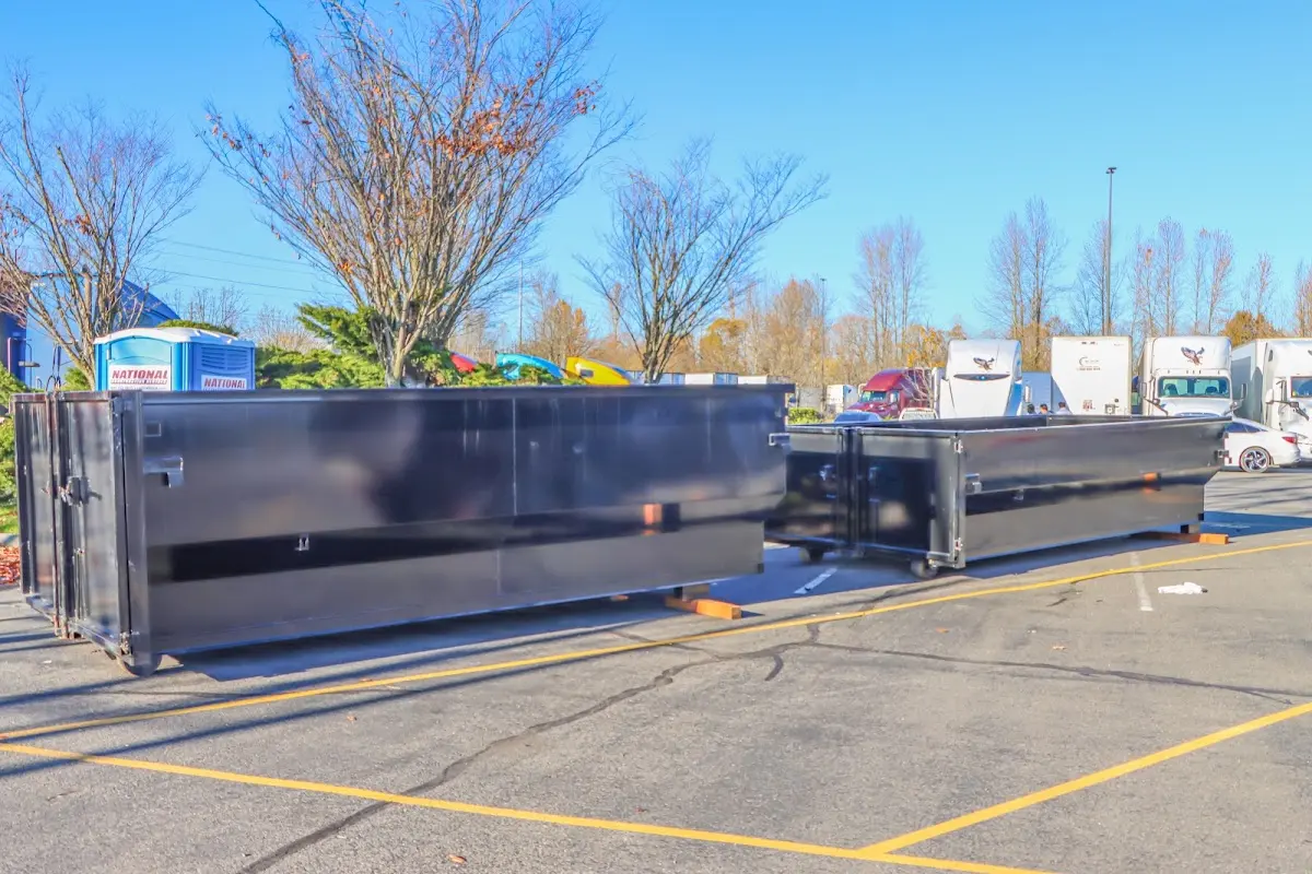 Professional dumpster rental service with roll-off container on residential driveway in Ballston